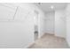 Spacious walk-in closet with wire shelving and neutral carpeting, leading to ensuite bathroom at 41 Silver Moon Ln # 115, Clayton, NC 27527