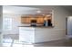 Open-concept kitchen with wood cabinets and a breakfast bar overlooking the dining area at 441 Hill Rd, Rougemont, NC 27572