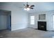 Cozy living room with a fireplace, ceiling fan, and neutral carpeting at 441 Hill Rd, Rougemont, NC 27572