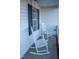 Welcoming front porch featuring classic white rocking chairs at 441 Hill Rd, Rougemont, NC 27572