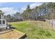 A spacious backyard with a sandbox, lawn, and mature trees at 457 Cokesbury Park Ln, Fuquay Varina, NC 27526