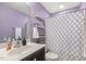 Well-lit bathroom with a shower, a toilet, a sink, and shelves at 457 Cokesbury Park Ln, Fuquay Varina, NC 27526