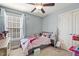 A cozy bedroom with a single bed, window, and playful decor at 457 Cokesbury Park Ln, Fuquay Varina, NC 27526