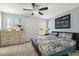 This spacious bedroom features a large bed, dresser, ceiling fan, and natural light from windows at 457 Cokesbury Park Ln, Fuquay Varina, NC 27526