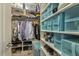 Organized walk-in closet features shelving with clothes, shoes, and storage boxes at 457 Cokesbury Park Ln, Fuquay Varina, NC 27526