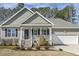 Charming single Gathering home featuring a cozy porch and well-maintained landscaping at 457 Cokesbury Park Ln, Fuquay Varina, NC 27526