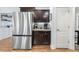 This kitchen includes a stainless steel refrigerator, dark wood cabinets, and granite countertops at 457 Cokesbury Park Ln, Fuquay Varina, NC 27526