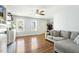 Bright living room features wood floors and a comfortable sectional sofa at 457 Cokesbury Park Ln, Fuquay Varina, NC 27526