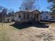 Charming bungalow-style home with a yard and a detached swing set at 464 Powell St, Henderson, NC 27536