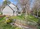 Fenced backyard featuring a large lawn, a deck, and mature trees at 4745 Grand Cypress Ct, Raleigh, NC 27604