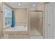 Bright bathroom featuring a garden tub next to tiled shower and window for natural light at 4745 Grand Cypress Ct, Raleigh, NC 27604