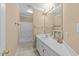 This cozy bathroom has a single vanity, tiled floors, framed mirror, and a tub with a shower at 4745 Grand Cypress Ct, Raleigh, NC 27604