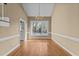 Dining area with hardwood floors, a chandelier, and a large window offering natural light at 4745 Grand Cypress Ct, Raleigh, NC 27604