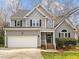 Charming two-story home featuring a gray exterior, attached garage, and well-maintained landscaping at 4745 Grand Cypress Ct, Raleigh, NC 27604