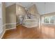 Spacious living room with hardwood floors, a staircase, and a vaulted ceiling at 4745 Grand Cypress Ct, Raleigh, NC 27604