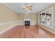 Cozy living room with hardwood floors, fireplace, and access to screened in back porch at 4745 Grand Cypress Ct, Raleigh, NC 27604