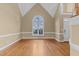 Bright living room featuring vaulted ceilings, a large window, and hardwood floors at 4745 Grand Cypress Ct, Raleigh, NC 27604