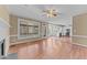 Open-concept living room with hardwood floors and easy access to the kitchen and screened-in porch at 4745 Grand Cypress Ct, Raleigh, NC 27604