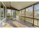 A screened porch with a wood deck and railing offers an outdoor living space at 4745 Grand Cypress Ct, Raleigh, NC 27604