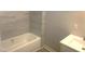 Bathroom features a shower and tub, tiled walls, and vanity, offering a practical and comfortable space for self-care at 523 E Nelson Ave, Wake Forest, NC 27587