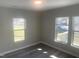 Bright bedroom featuring neutral walls, hardwood floors, and windows, creating a serene and comfortable atmosphere at 523 E Nelson Ave, Wake Forest, NC 27587