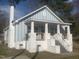 Charming home with light blue painted wood and brick porch with craftsman railing at 523 E Nelson Ave, Wake Forest, NC 27587