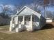 Quaint two-story home featuring a light blue exterior, brick porch, and manicured front lawn at 523 E Nelson Ave, Wake Forest, NC 27587