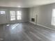 Cozy living room with hardwood floors, fireplace, and ample natural light creating an inviting atmosphere for relaxation at 523 E Nelson Ave, Wake Forest, NC 27587
