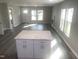 Spacious living room featuring many windows, modern flooring and light gray painted walls at 523 E Nelson Ave, Wake Forest, NC 27587