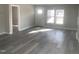 Inviting living room showcasing hardwood floors, freshly painted walls, and an abundance of natural light from the windows at 523 E Nelson Ave, Wake Forest, NC 27587