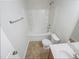 Bathroom featuring a tub, toilet, and sink with tile flooring and natural light at 543 Camel St, Clayton, NC 27520