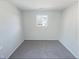 Empty bedroom with light gray carpet and one window providing natural light at 543 Camel St, Clayton, NC 27520