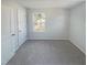 Neutral bedroom with a light gray carpet, a window, and white door and trim at 543 Camel St, Clayton, NC 27520