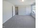 Bright bedroom with soft carpet, a large window, and doors at 543 Camel St, Clayton, NC 27520
