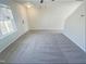 Bright living room with soft carpet and a large window at 543 Camel St, Clayton, NC 27520