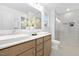 Bathroom with double sinks, wooden vanity, and a glass-enclosed shower at 55 Mable Court # 5, Lillington, NC 27546