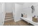 Inviting entryway featuring coat hooks, seating, and a carpeted staircase at 55 Mable Court # 5, Lillington, NC 27546