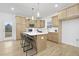 Spacious kitchen with a center island, pendant lights, and stainless steel appliances at 55 Mable Court # 5, Lillington, NC 27546