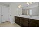 Bathroom featuring a double sink vanity, a large mirror, and a walk-in shower at 5601 Garnet Meadow Rd, Knightdale, NC 27545