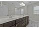Bathroom featuring a double sink vanity and a large mirror at 5601 Garnet Meadow Rd, Knightdale, NC 27545