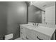 Bathroom features a gray wall, wood floors, large vanity and undermount sink at 5601 Garnet Meadow Rd, Knightdale, NC 27545