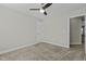 Bright bedroom features neutral walls, plush carpet, ceiling fan, and plenty of natural light at 5601 Garnet Meadow Rd, Knightdale, NC 27545