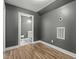 Bonus room features recessed lights, gray walls, wood floors, and an ensuite bathroom at 5601 Garnet Meadow Rd, Knightdale, NC 27545