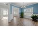 Bright dining room featuring light-colored walls, wood floors, modern chandelier, and plenty of natural light at 5601 Garnet Meadow Rd, Knightdale, NC 27545