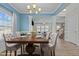 Elegant dining room with a stylish chandelier, a large table, and an open view into the living space at 5601 Garnet Meadow Rd, Knightdale, NC 27545