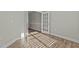 Empty room with wood flooring, neutral walls, and a door with glass panels for versatile use at 5601 Garnet Meadow Rd, Knightdale, NC 27545