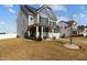 Charming two-story home featuring a manicured lawn and a welcoming front porch with stately white columns at 5601 Garnet Meadow Rd, Knightdale, NC 27545
