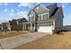 Beautiful gray home with a spacious driveway, attached garage, and landscaped front yard, perfect for curb appeal at 5601 Garnet Meadow Rd, Knightdale, NC 27545