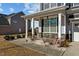 Charming front entrance featuring stone accents, lush landscaping, and a covered porch with elegant columns at 5601 Garnet Meadow Rd, Knightdale, NC 27545