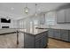 Well-lit kitchen featuring an island with a granite countertop and convenient access to the living area at 5601 Garnet Meadow Rd, Knightdale, NC 27545